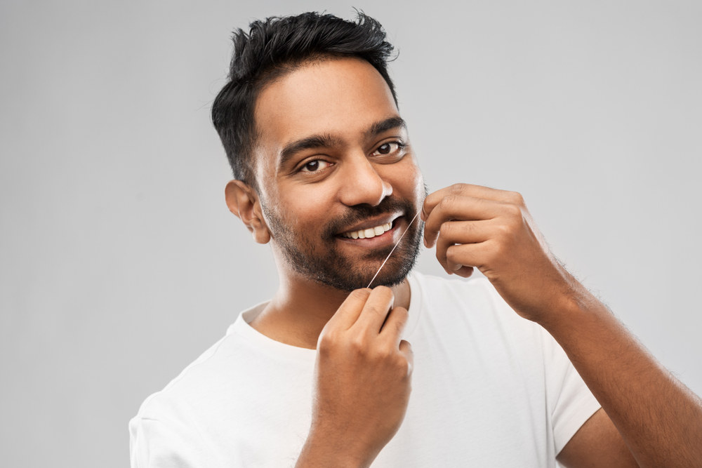 Man Flossing - The Ultimate Guide to Flossing