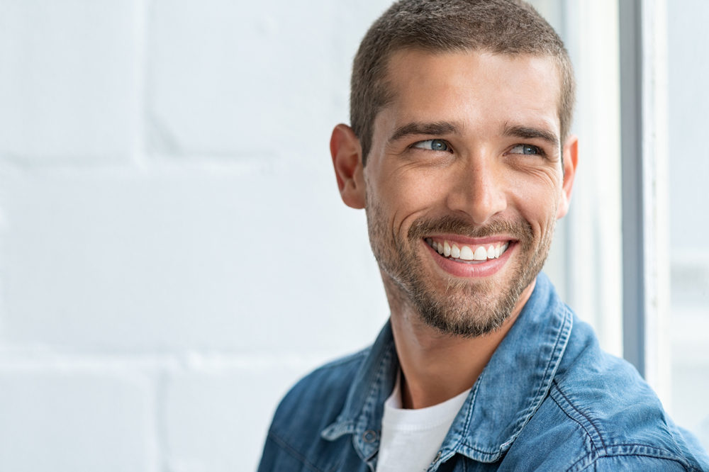 Man smiling - What You Can Do To Maintain Your Oral Health