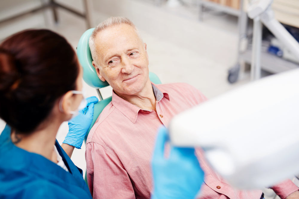 Patient getting tooth extraction at dentist